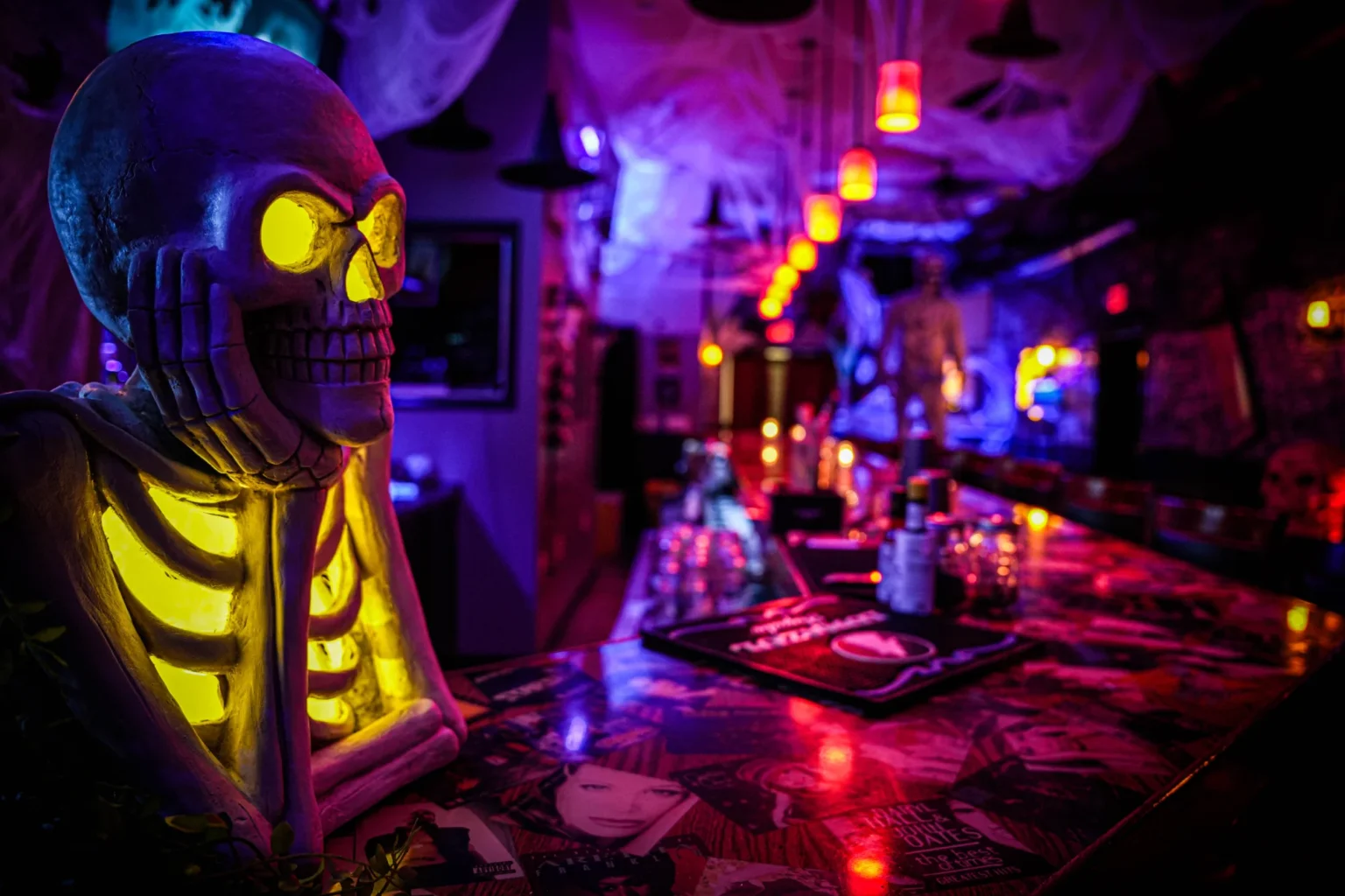 a skeleton statue sitting on top of a bar