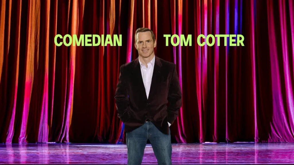 a man standing in front of a red curtain