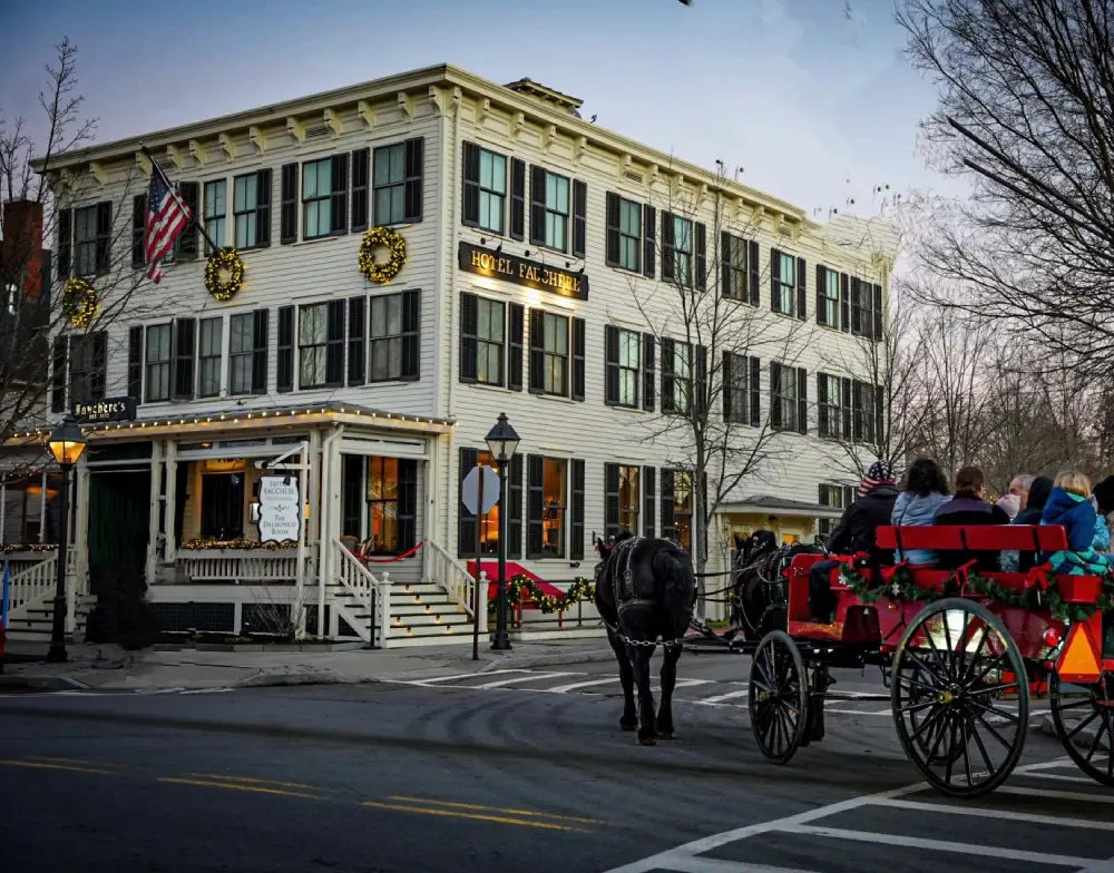 a horse drawn carriage traveling down a street